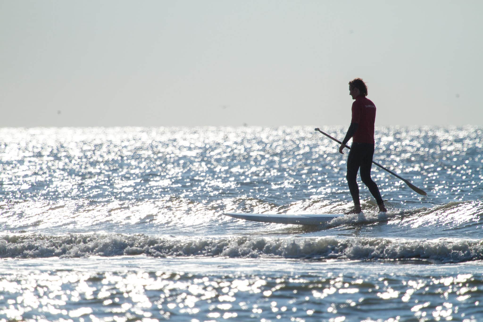 Mannelijke supper staand op een supboard in de noordzee