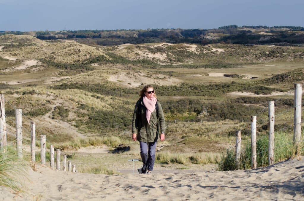 Vrouw wandelend door de duinen van amsterdamse waterleidingduinen