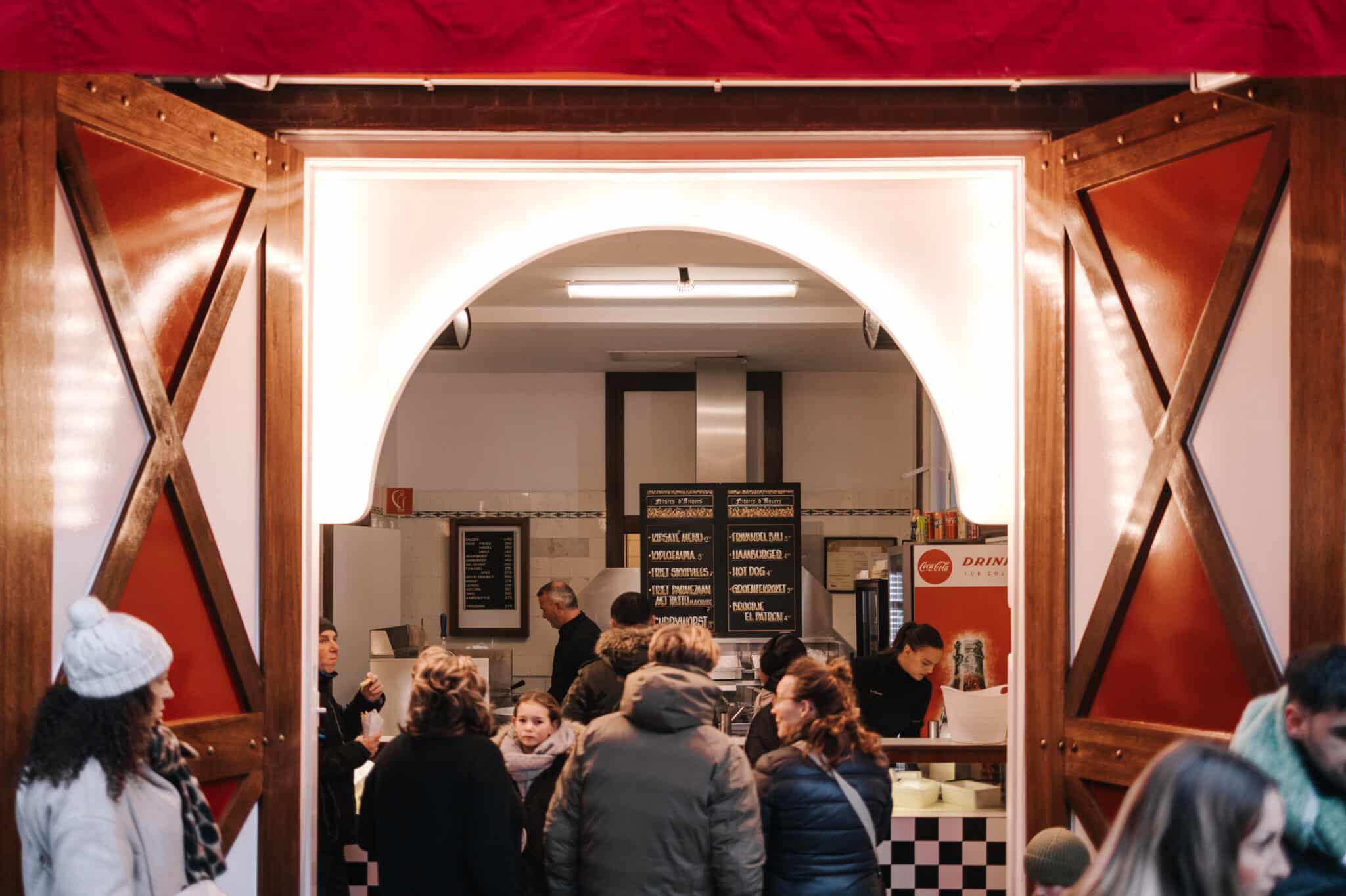 Mensen staan in de rij voor een frietje bij Friture d'Anvers.