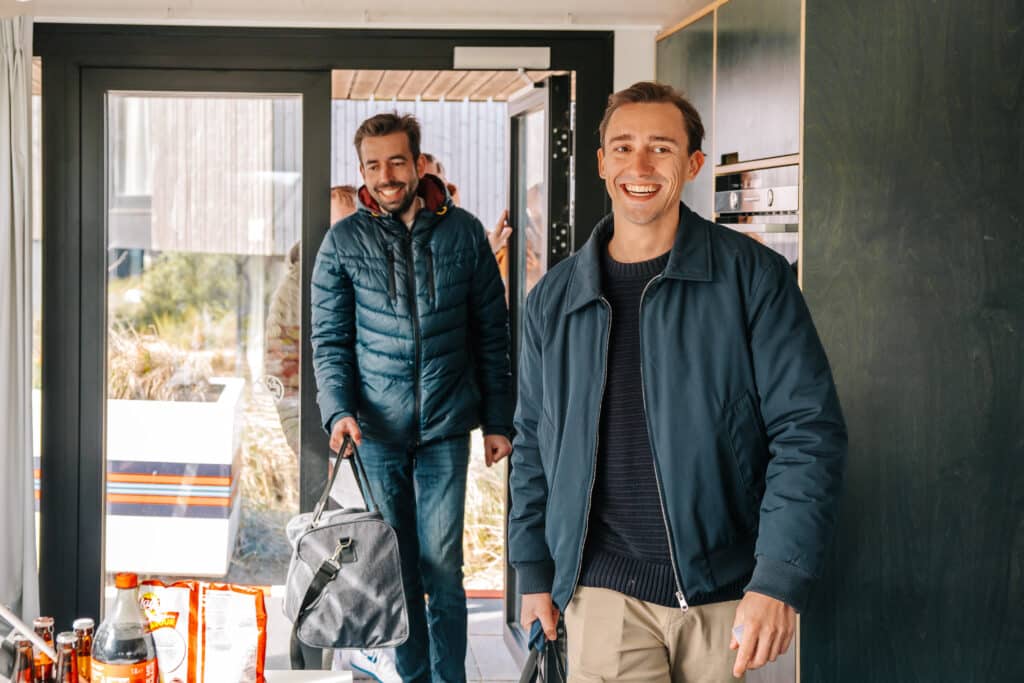 mannen lopen een huisje bij Roompot binnen tijdens hun vriendenarrangement
