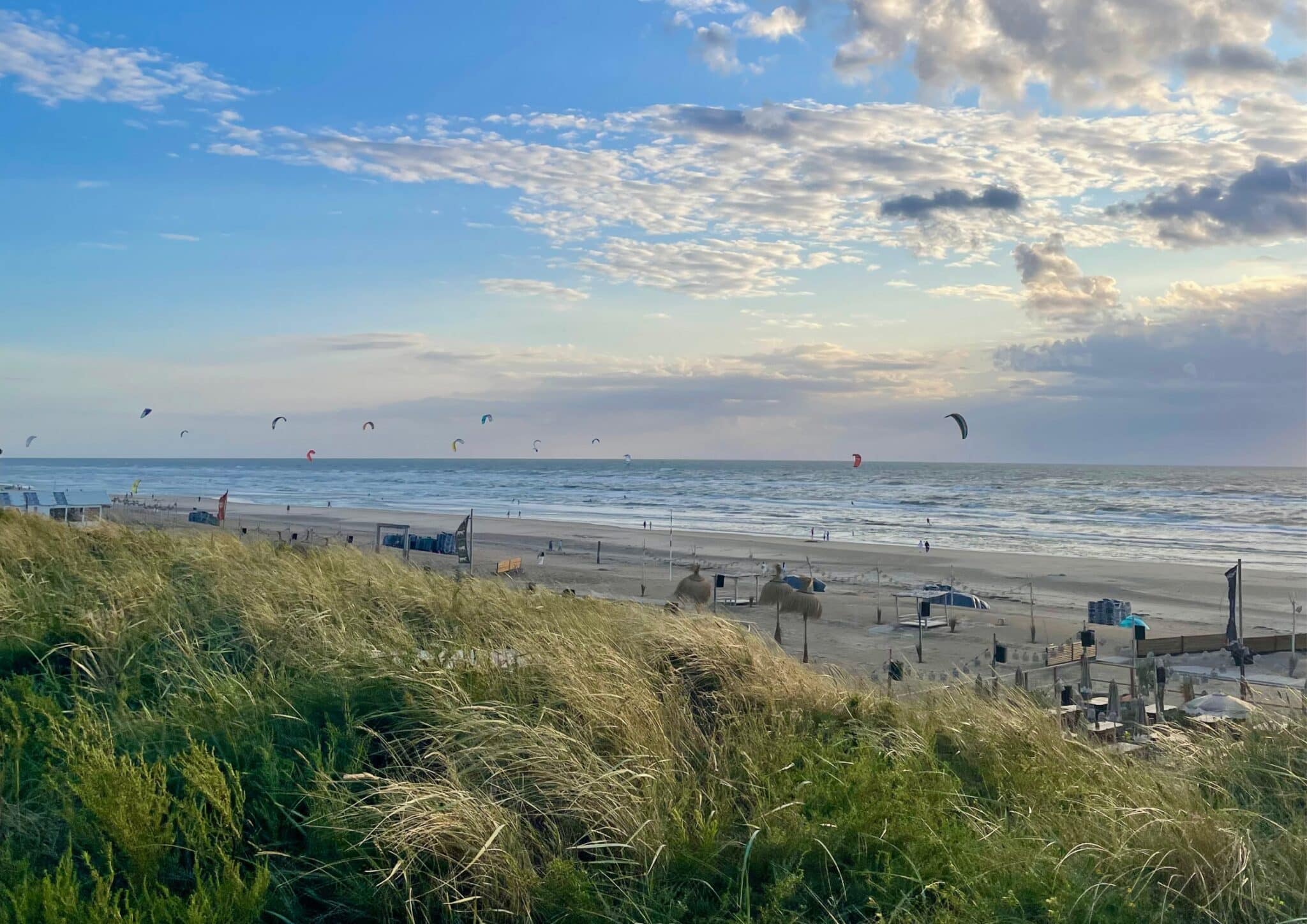 Strand van Zandvoort vanaf de Boulevard met veel kitesurfers in zee