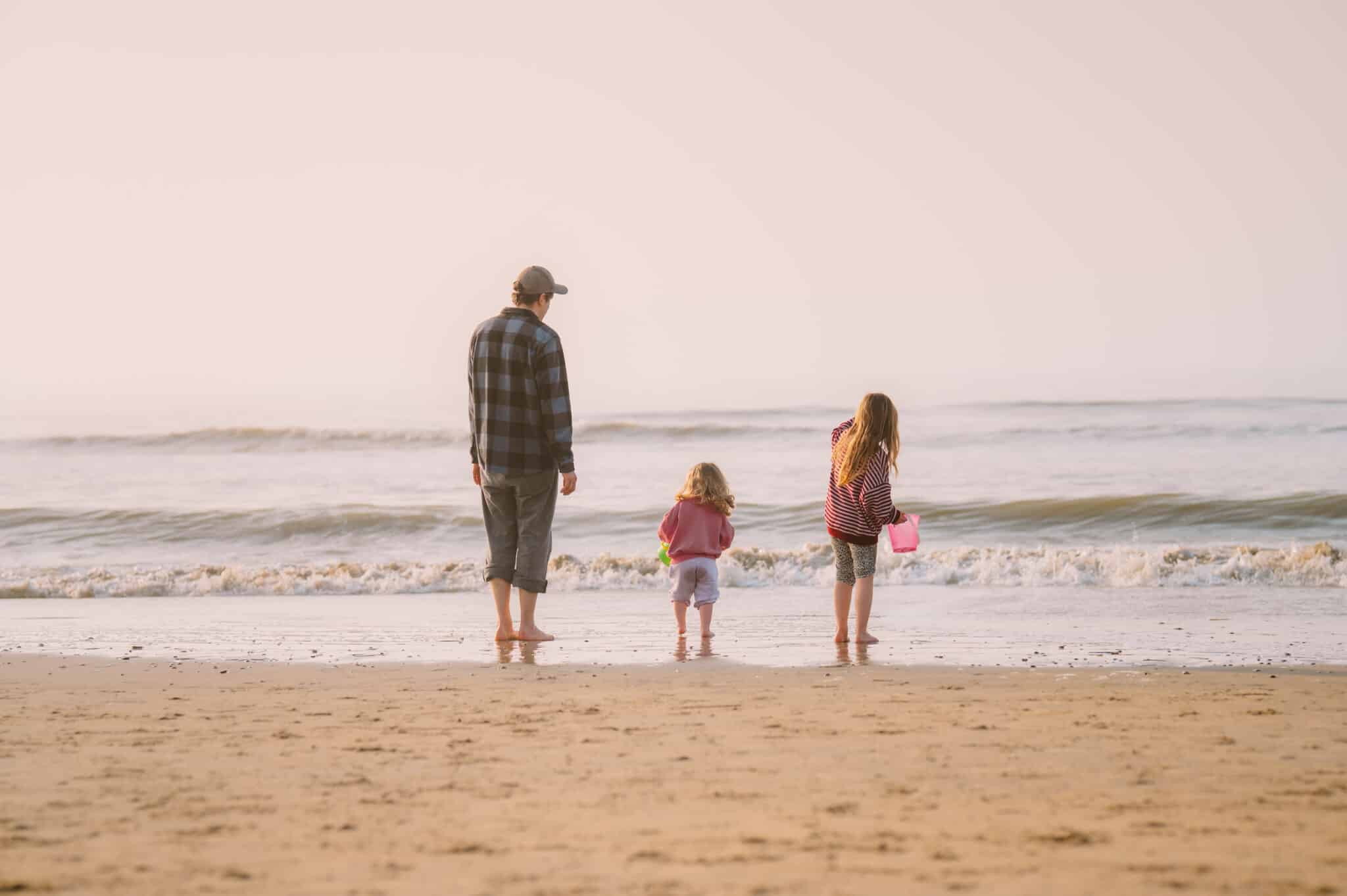 Vader met kinderen op het strand van Zandvoort in het voorjaar